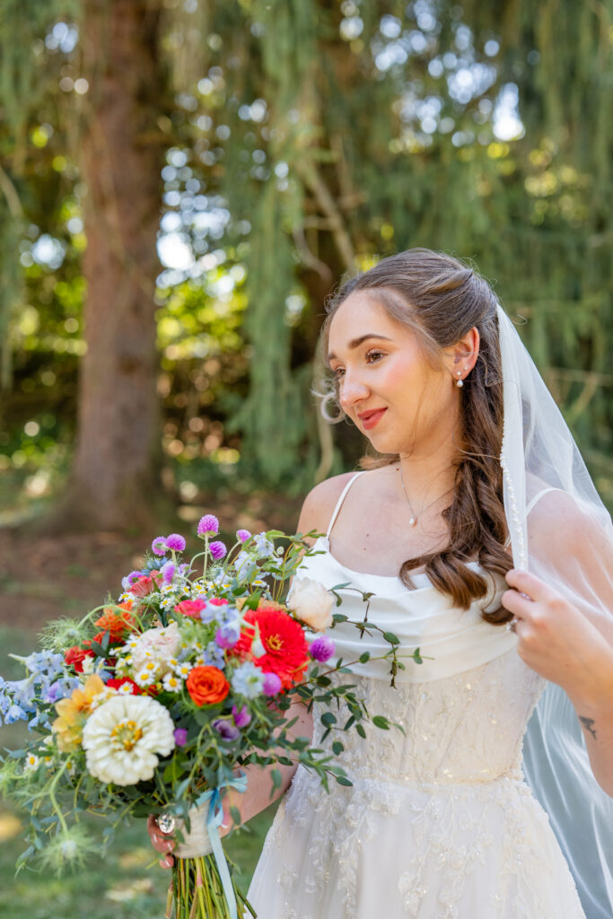 Outdoor bridal portrait in Pittsburgh featuring a bride holding a vibrant bouquet in natural light.