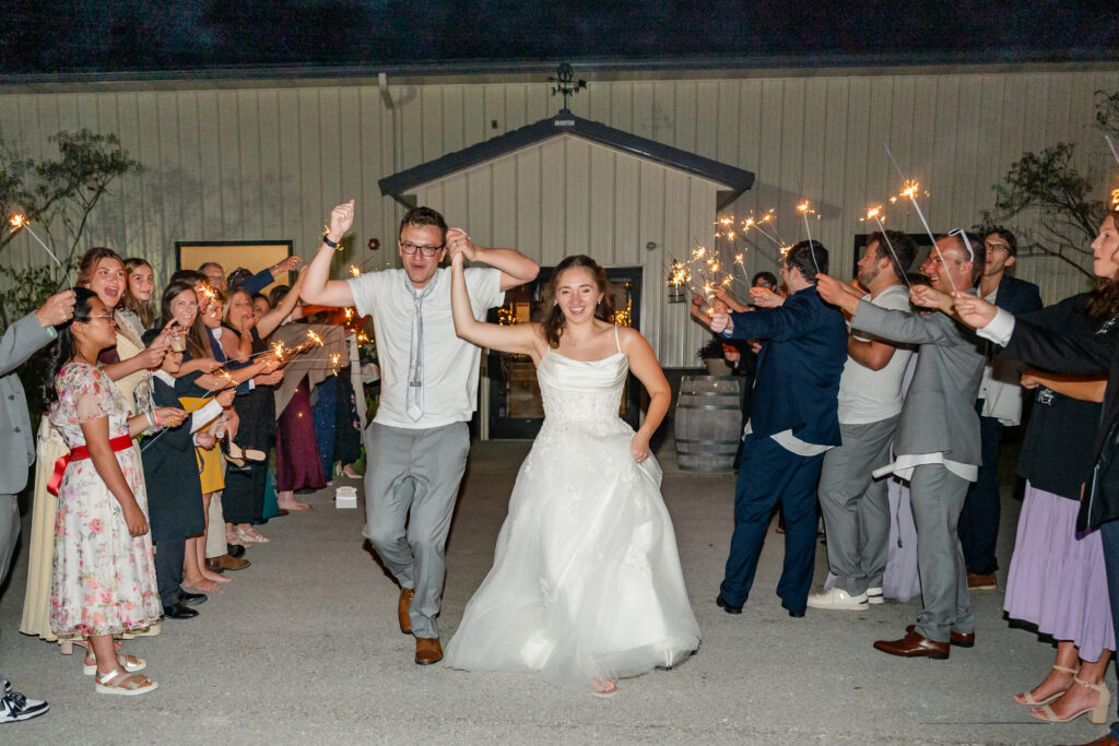 Wedding sparkler exit in Pittsburgh featuring a newlywed couple celebrating with guests at night.